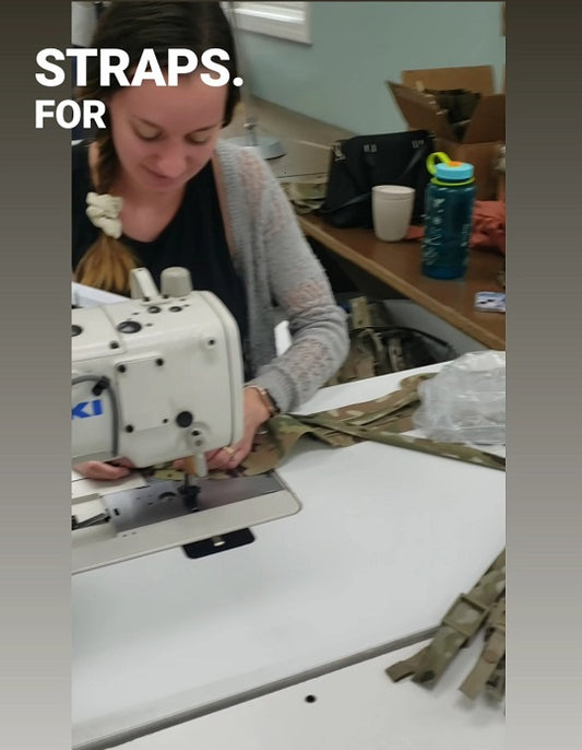 Woman sewing backpack straps for Squatch Survival Gear, showcasing American-made craftsmanship.