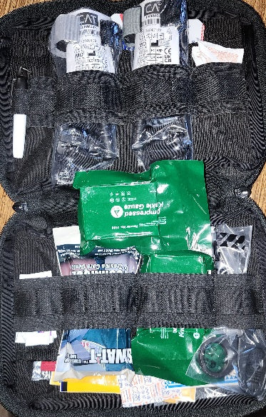 Squatch Survival Gear Emergency Response Kit—featuring NAR CAT 7 tourniquets, chest seals, compressed gauze, bandages, quick clot, shears, gloves, and burn ointments. A rugged, field-ready medical kit designed for tactical, survival, and emergency preparedness.