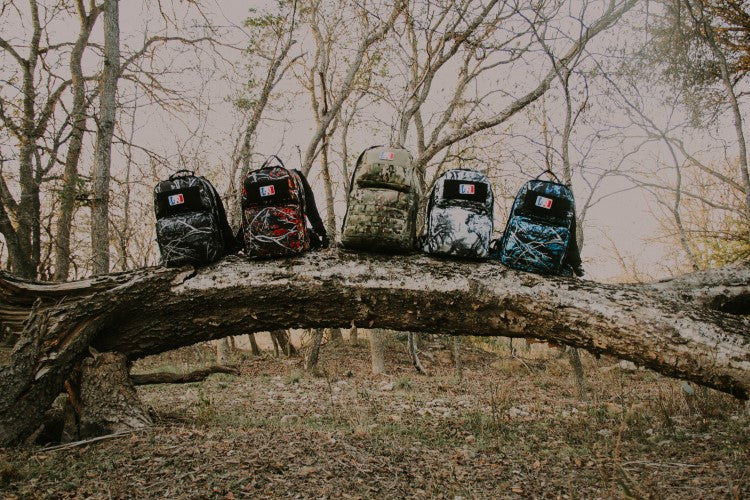 backpack on tree - american made backpacks - rugged american made backpack - backpacks - ocp  - multicam camo - sirphis camo - moon shine - wildfire - undertow - hiking - camping - survial - emergency response - disaster response - squatch survival gear 
